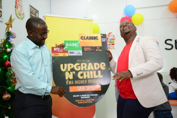 Aldrine Nsubuga StarTimes Regional Marketing Director (left) and Content Director Myke Mwai gestures during the upgrade campaign launch.