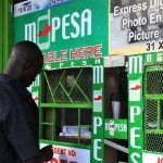 A customer at a Safaricom M-Pesa agent outlet. Safaricom's Fuliza overdraft service launched in 2019 has proved wildly successful for the firm's bottomline even as citizens and policy-makers raise concerns. [Photo/ Courtesy]