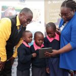 Joan Mwachi-Amolo, Regional Director at Worldreader and Walter Olando, Director of Bethany Joy School in Kawangware introducing pupils to the digital learning application during the launch of a survey on the successof digital reading in schools and communities.