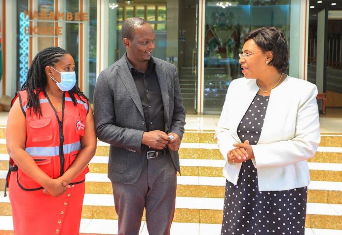 From left: Kenya Red Cross, Deputy Secretary General-Programmes, Annete Msabeni, MD Mpesa Africa & Chief Financial Services Officer, Sitoyo Lopokoyit engage with Cabinet Secretary, Ministry of Public Service, Gender and Senior Citizens Affair and Special Programmes. Margaret Kobia during the launch of Emergency Relief Cash Transfer at Harambee House.