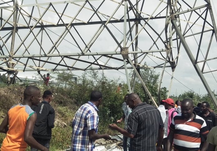 Onlookers mill at the scene of the collapse of Kenya Ppwer's high voltage transmission tower lines in the Imara Daima area on January 11, 2022. [Photo/ @JamalGadaffi]