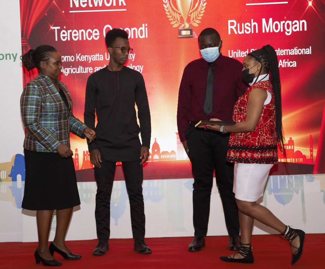 Lucy Mulili (left) presents certificates and trophies to the winners of the just concluded Huawei National ICT competition. [Photo/ Courtesy]