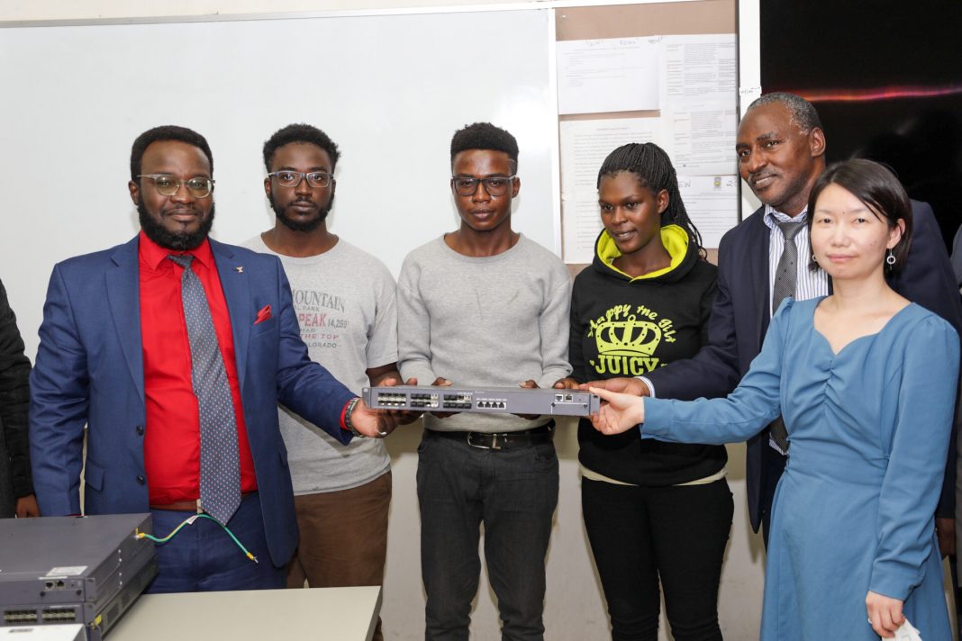 JKUAT Deputy Vice Chancellor Professor Robert Kinyua (far left) poses with students and faculty when the institution officially launched the Datacomm network engineers training program. Looking on is Huawei Deputy CEO Public Affairs Fiona Pan (Far right)