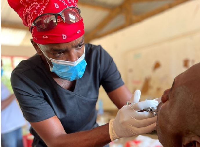 Dr. Tim Theuri, President, Kenya Dental Association, performs a dental procedure on a patient from Lamu during their recent free mobile dental clinic in the region, in partnership with Mars Wrigley’s Wrigley Oral Healthcare Program.