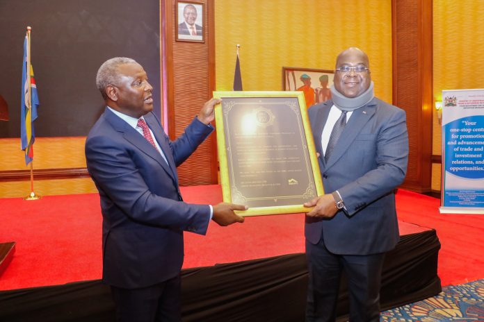 H.E Felix Tshishekedi, President of the Democratic Republic of Congo (right) receives a memento from Dr. James Mwangi Equity Group Managing Director and CEO (left) during a corporate dinner organized by Equity Group to celebrate the signing of the accession treaty by DRC after admission into the East African Community (EAC) and in furtherance of the Kenya-DRC Trade relations.