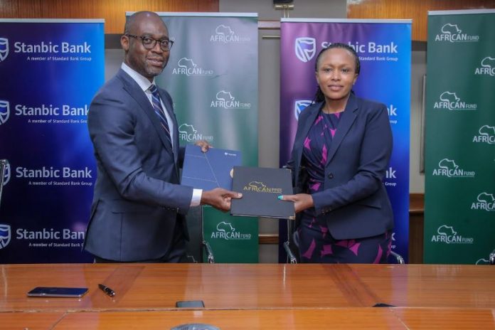 Head of Business and Commercial clients Stanbic Bank, Florence Wanja (R) Group Director of Business Development African Guarantee Fund Frank Adjagba (L) during the signing of the agreement between Stanbic Bank and Africa Guarantee Fund.
