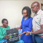 From Right: M-PESA Foundation Representative, Onesmus Mulu, the First Lady of Tharaka-Nithi county Mrs. Margaret Njuki, hand over a gift hamper at one of the fistula surgery beneficiary Juliet Ciantuni.