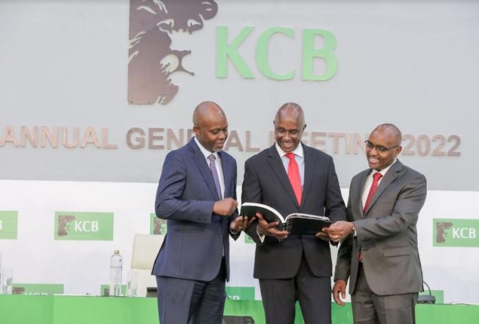 From Left: KCB Group Chief Financial Officer, Lawrence Kimathi, Group Chairman Andrew Wambari Kairu and Group CEO Mr. Paul Russo peruse through the 2021 Integrated Report during the bank's 51st Annual General Meeting conducted virtually. During the meeting, shareholders approved KShs. 9.64 billion total dividends pay-out for the 2021 financial year.