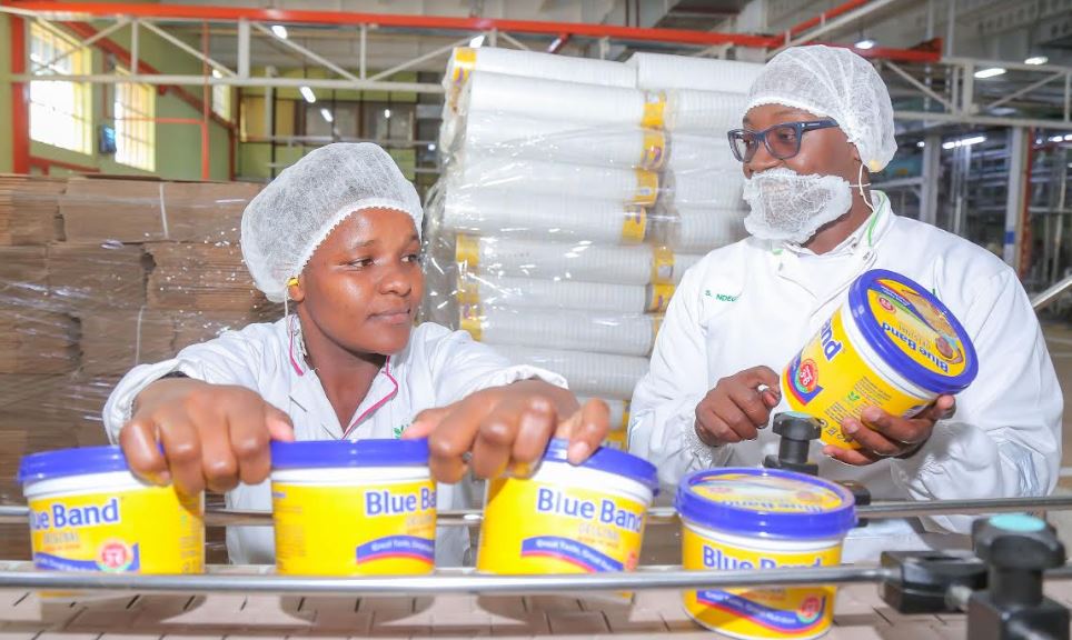 Upfield Head of Manufacturing Simon Ndegwa (R) and Mercy Kathure (L) showcase the production process during activities to mark World Food Safety Day. The theme for this year is Safer food, better health