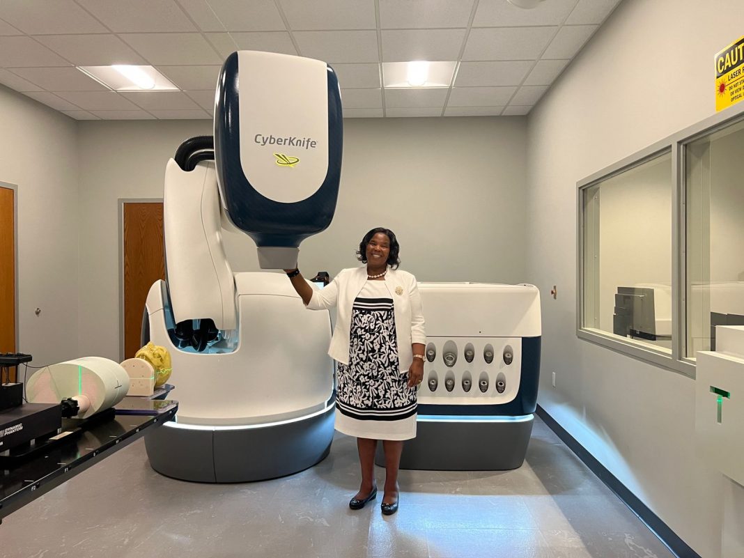 KUTRH Board Chairperson Prof. Olive Mugenda poses with the CyberKnife machine. [Photo/ @OliveMugenda]