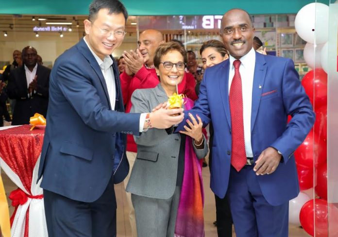 Diamond Trust Bank (DTB) Kenya customer James Pan (left) joins DTB Group Chief Executive Officer Nasim Devji and Chairperson Linus Gitahi (right) at the official opening of the new DTB Imaara Branch