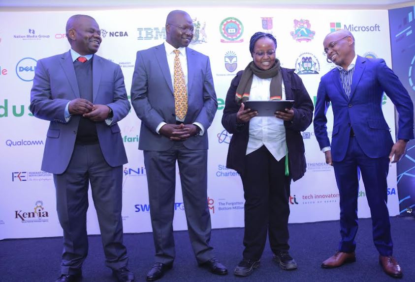 From left, Principal Secretary Ministry of ICT Jerome Ochieng, Cabinet Secretary Ministry of Labour & Youth Affairs, Simon Chelugui and Safaricom PLC CEO Peter Ndegwa look on as Sylvia Wangari takes them through a digital concept. This was during the launch of the Industry Digital talent programme at the Safaricom offices.