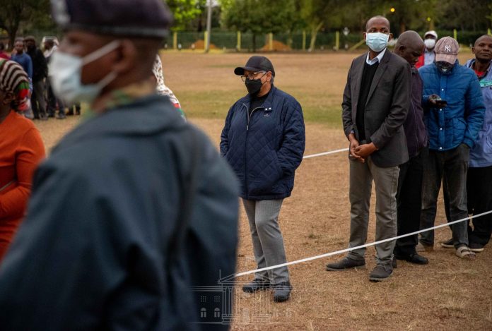 First Lady Margaret Kenyatta queues as she waits to vote at St Mary's School polling station in Lavington, Dagoretti North Constituency in Nairobi City County. [Photo/ @StateHouse Kenya]