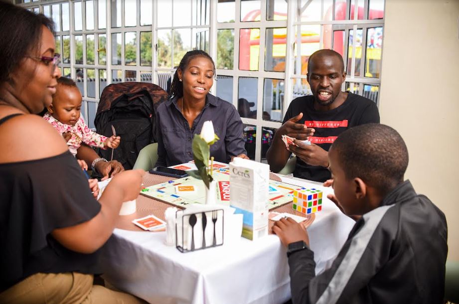 A group of friends play a game of Monopoly at Mint Mua Restaurant.