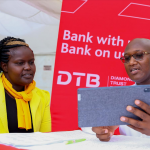Lawi Mbira, Head of Sales, DTB Bank assist Caroline Rono open a zawadi account in Nakuru. Zawadi account is tailor made for women running small and medium enterprises and it is designed to enable women access favorable credit terms to grow their business.Lawi Mbira, Head of Sales, DTB Bank assist Caroline Rono open a zawadi account in Nakuru. Zawadi account is tailor made for women running small and medium enterprises and it is designed to enable women access favorable credit terms to grow their business.