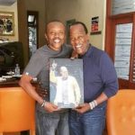 Jeff Joinange (R) pictured with Classic FM presenter Maina Kageni, holding a painting. [Photo/ KDRTV]