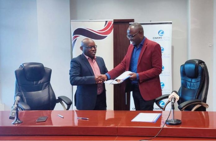 Mediamax Networks CEO Ken Ngaruiya and Chams Media CEO Alex Chamwada during the signing of the contract on Thursday at DSM Place, Nairobi.