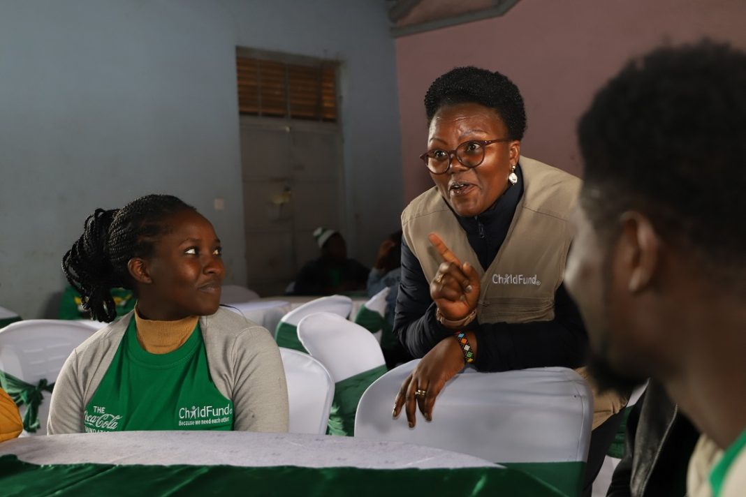 ChildFund Kenya Country Director Alice Anukur chats with youth participants during the launch