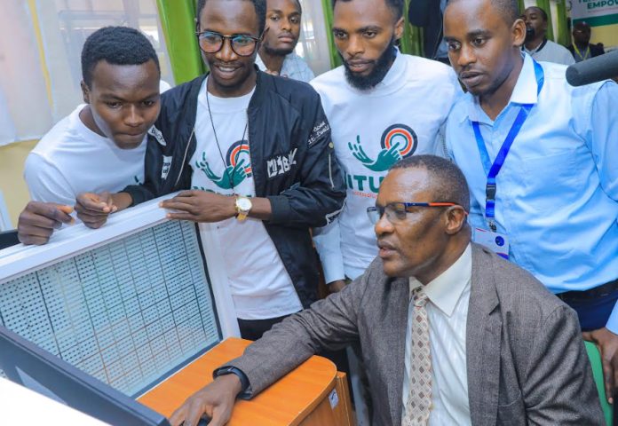 ICT & Digital Economy CS Eliud Owalo interacting with the students at the Jitume Lab after the launch in Eldoret National Polytechnic, Eldoret.