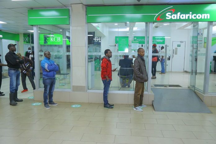 Kenyans line up at a Safaricom shop. [Photo/ Jambo]