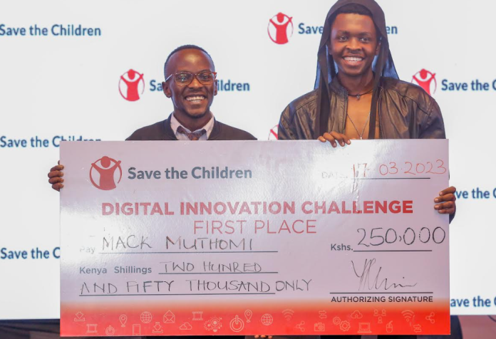 From left, Mack Muthomi and Alex Mwaniki of Toto Register pose for a photo with the awarded dummy cheque during the award ceremony