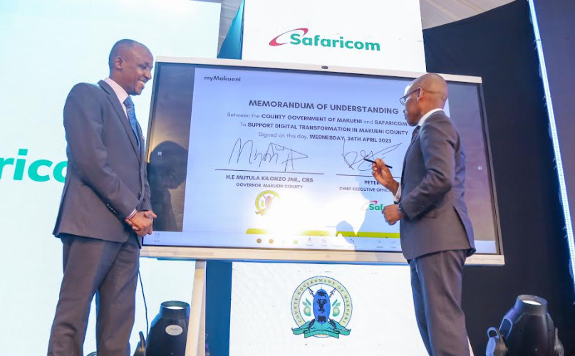 Mutula Kilonzo, Governor - Makueni County. and Peter Ndegwa, CEO Safricom, sign an MOU during the launch first of the first of its kind MyCounty App in Makueni County