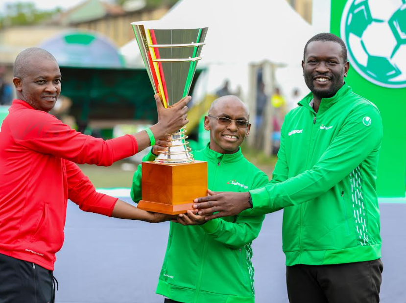 FKF President Nick Mwendwa (L), Safaricom CEO Peter Ndegwa (c) and Nairobi County Senator Edwin Sifuna(R) lifts the Safaricom Chapa Dimba season 4 trophy during the official launch of the tournament at Camp Toyoyo Ground, in Makadara, Nairobi.