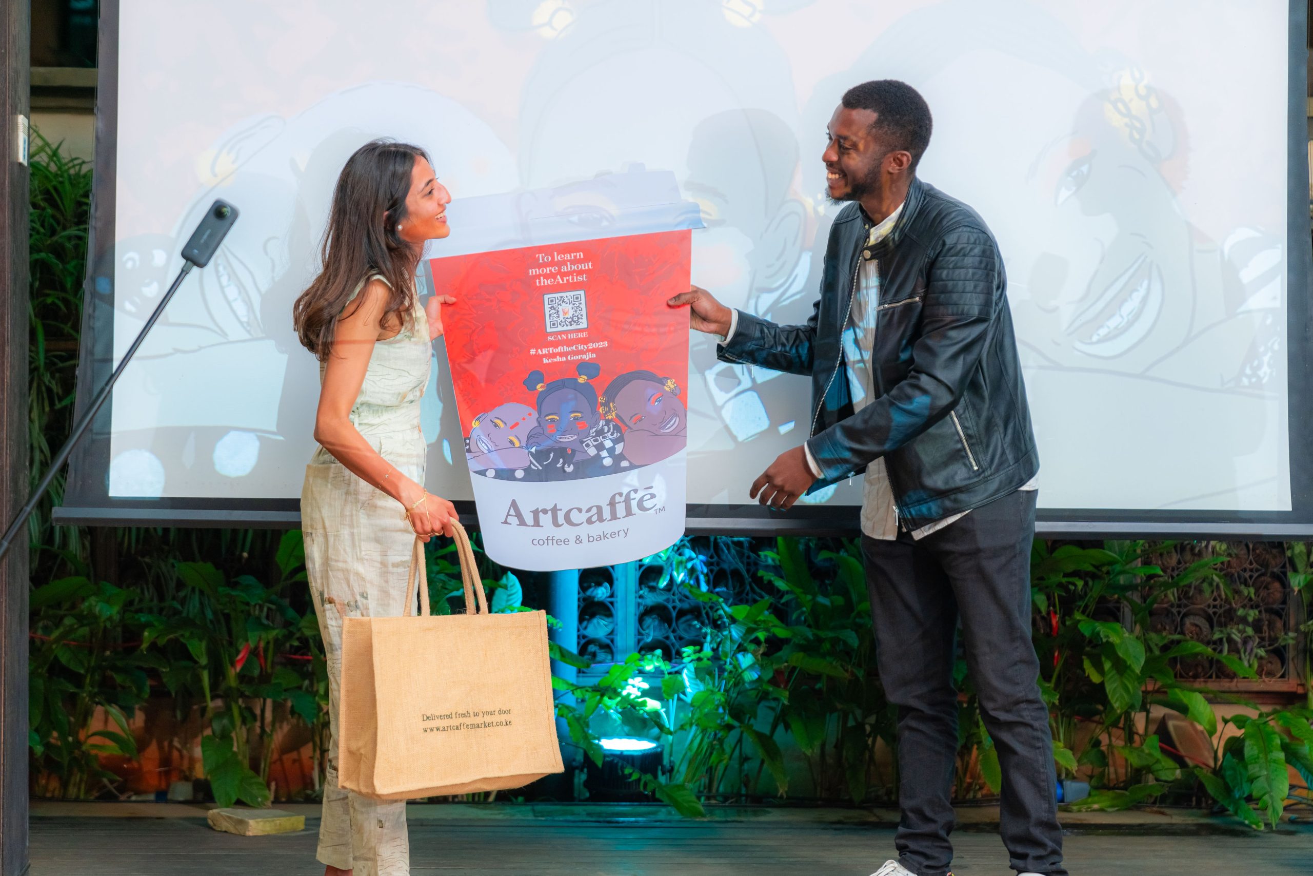 Grand winner - Kesha Gorajia receivin g her award from previous winner of Art of the City, Cyprian Kiswili