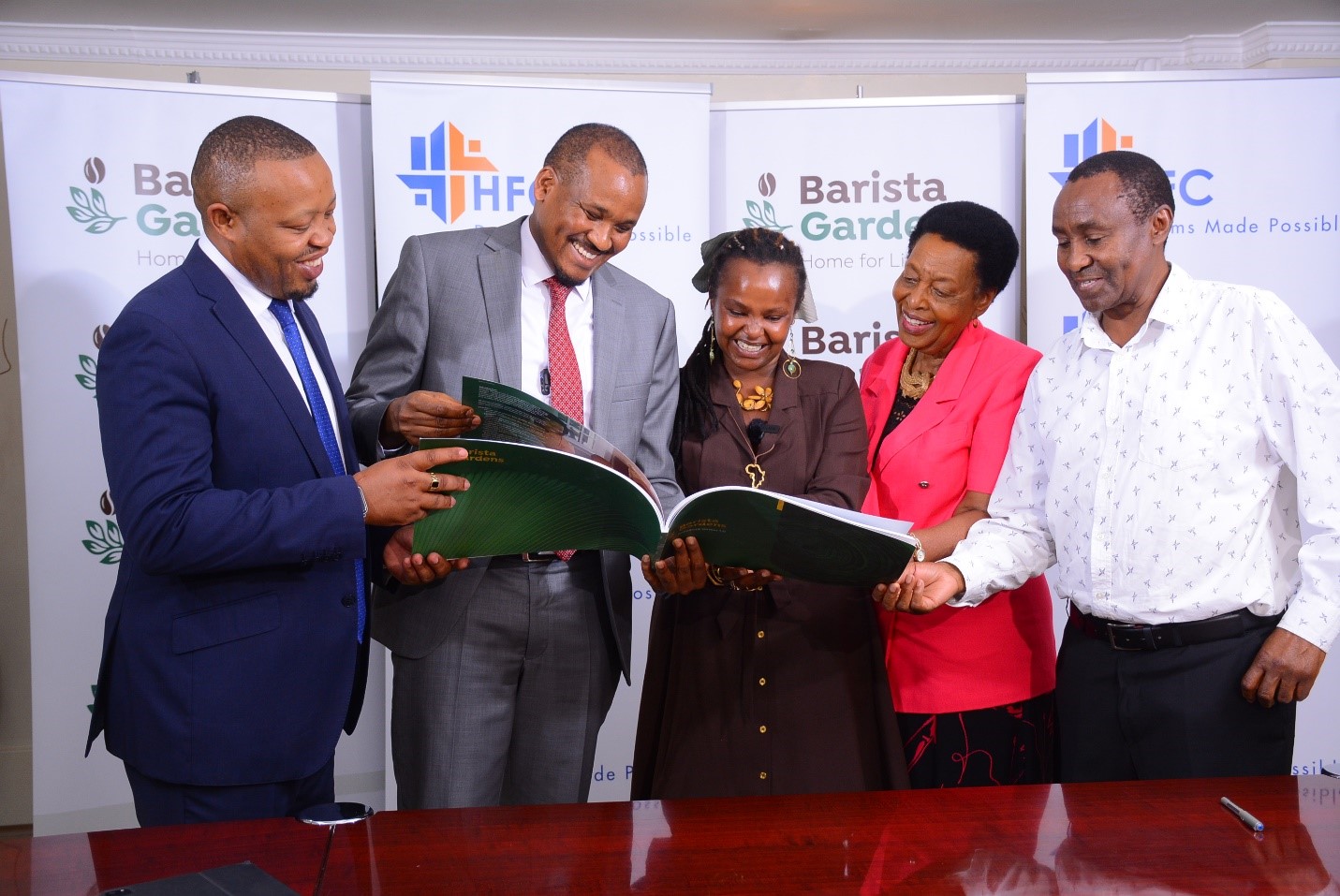 HFDI Executive Director Joseph Kamau, HF Group CEO Robert Kibaara, Barista Gardens Chairlady Nyokabi Kamau, Directors Wambui Kimani and Kairu Mukunga review Barista Garden’s Brand Book. HF Group’s banking subsidiary HFC has partnered with Kigutha Farmers Limited to add value to the latter’s 58 acres parcel of land in Kamiti Corner, Kiambu County.