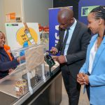 Eva Ngigi Sarwari(R), Michael Kungu(C) KCB Bank Ag. Retail Banking Director KCB being served by Grace Kimani(L) Cashier Naivas supermarket as they use the KCB’ VISA cashless Tap to pay through the phone. KCB Bank customers with Android handsets and Garmin wearables will now be able to make contactless payment transactions, deepening the uptake of cashless payments.