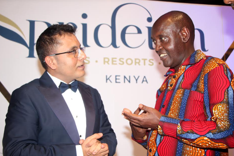 PrideInn Hotels, Resorts and Camps Managing Director Hasnain Noorani Left shakes and Tourism and Wildlife Principal Secretary John Olultaa during the unveiling of PrideInn's new brand identity.