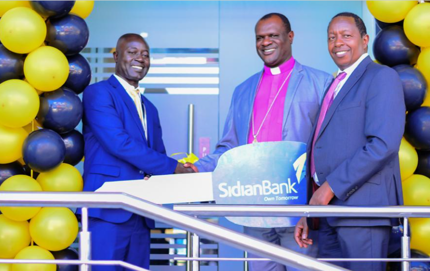 L-R Vitalis wekesa branch manager Kakamega ,Bishop Charles Asilutwa and Chege Thumbi CEO Sidian Bank at the launch of Sidian Bank in Kakamega County.