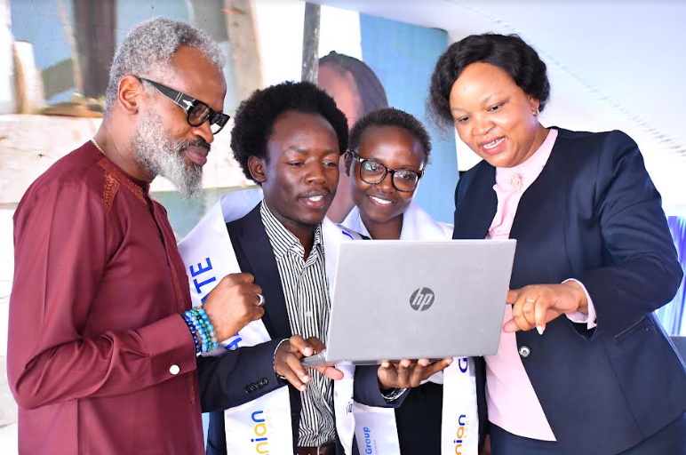 Adanian Labs CEO John Kamara and Family Bank CEO Designate Nancy Njau with graduates Barasa Brian and Cheryl Owala during the graduation ceremony of 250 youth graduating from a Software Development Training programme