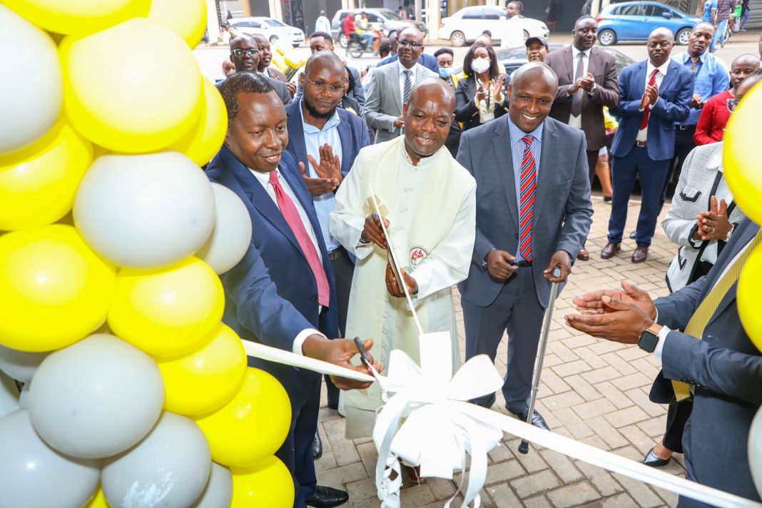 From Left Chief Executive Officer Sidian Bank Mr Chege Thumbi, Father Julius Morara , Director Strategy and Finance Mr Douglas Mwangi at the branch opening.