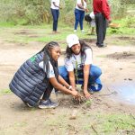 KCB Group Sustainability Manager, Charlotte Obado and KCB Sustainability Administrator, Amiss Kadzo, take part in the National Tree planting exercise at Nziu Wetlands in Makindu, Makueni County.