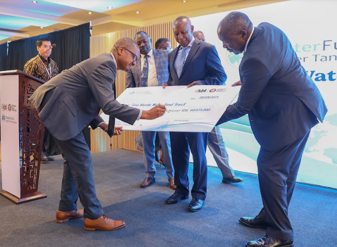 Eric Kiniti, Group Corporate Relations Director – EABL signs a cheque for Ksh 60 million during an event with stakeholders ahead of World Water Day celebrations on March 22. Looking on (R to L) on is Mr. Julius Korir, CBS, Principal Secretary, Ministry of Water, Sanitation and Irrigation, Eddy Njoroge, President, Upper Tana Nairobi Water Fund Trust (UTNWFT) and Laikipia Governor, Joshua Irungu.