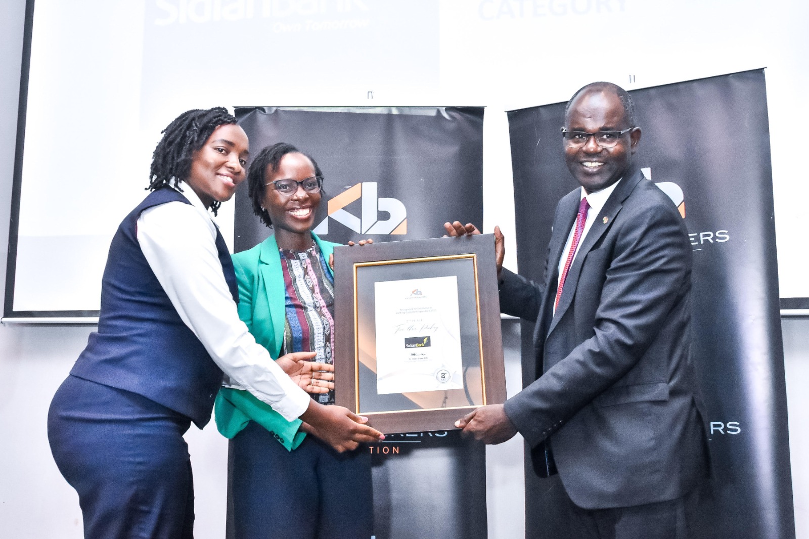 From right to left: Habil Olaka, CEO of Kenya Bankers Association, alongside Rita Mureithi, Customer Experience Manager, and Winnie Molly Owuor, Assistant Marketing Manager of Sidian Bank. [Photo/Sidian Bank]