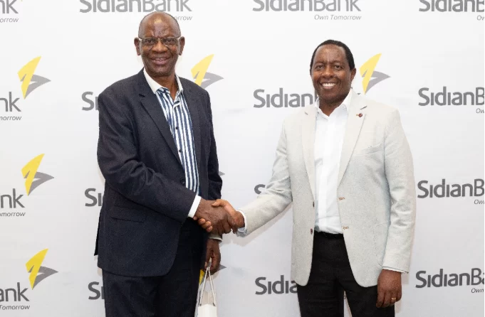 Sidian Bank CEO Chege Thumbi interacts with James Michura Michoma of Nakuplan Consultants Ltd. during a client’s engagement dinner in Nakuru County