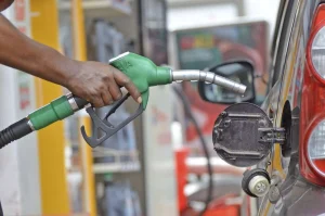 Man holding fuel pump at a filling station
