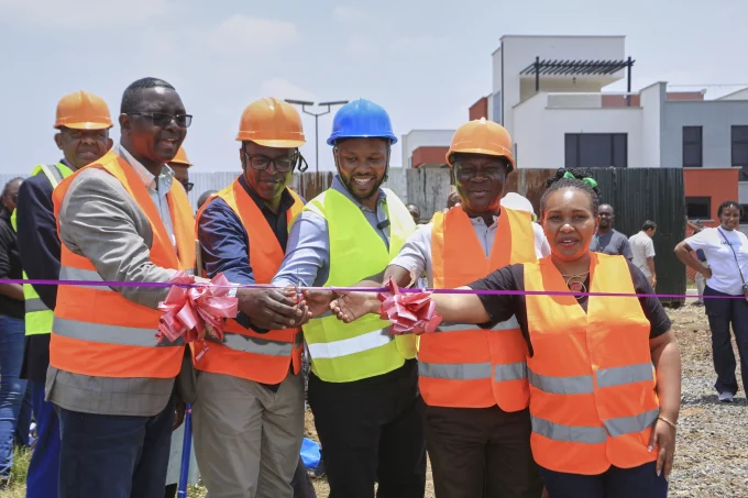 Geoffrey Gitaka, Director at Eboss Investments Company Ltd (center in blue hard hat), and Vincent Kihara, Head of Mortgage Finance at Co operative Bank of Kenya (second from left), join other dignitaries