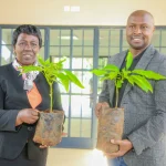 James Maitai, Chief Technology Information Officer, Safaricom PLC pose for a photo as he plants a tree at the UoN Lower Kabete campus.