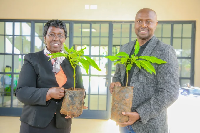 James Maitai, Chief Technology Information Officer, Safaricom PLC pose for a photo as he plants a tree at the UoN Lower Kabete campus.