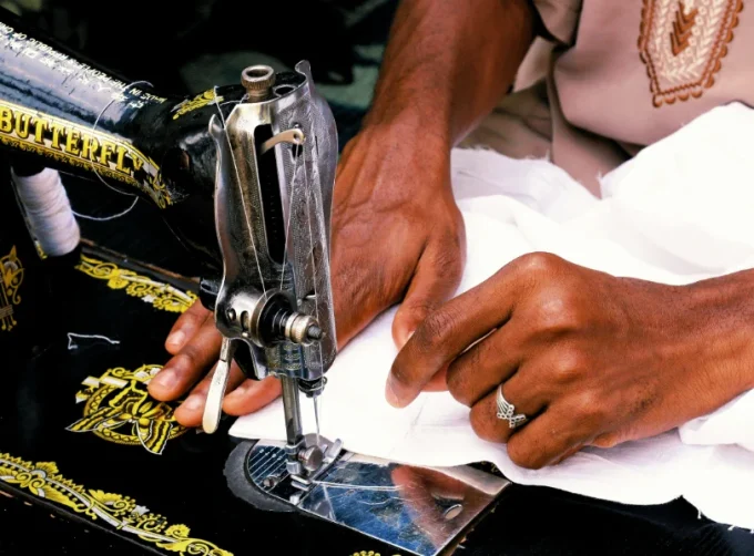 Tailor sewing a white textile. PHOTO/Pexels
