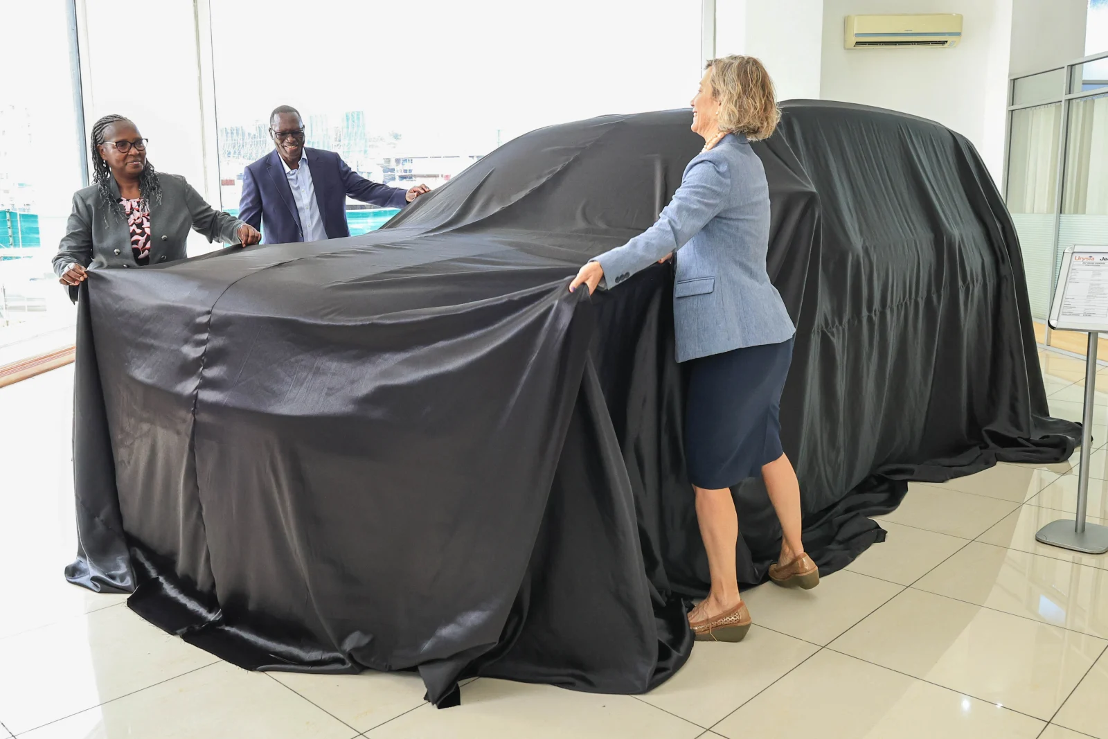 PS Trade Regina Ombam (L) US Embassy Deputy Head of Mission Carla Benini (R) and Urysia Ltd MD Claude Mwende unveil Jeep & Citroen as part of Urysia's expanded brand portfolio