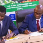 Ligane Sene, Deputy Representative and Senior Economist for UNDP in South Sudan sign-off the Workplan documents for the $20 million Rural Enterprise and Agriculture Development (READ) project with Elijah Wamalwa, the Managing Director Co-operative Bank of South Sudan.