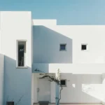 White 2-storey house near trees. PHOTO/Pexels