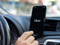 Uber driver checking phone. PHOTO/Pexels