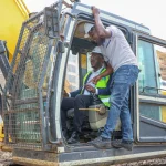 ERIC MULI, CEO MRE REAL ESTATE OPERATING THE EXCAVATOR DURING THE GROUND BREAKING CEREMONY OF MANYANJA MALL IN EASTLANDS.