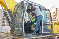 ERIC MULI, CEO MRE REAL ESTATE OPERATING THE EXCAVATOR DURING THE GROUND BREAKING CEREMONY OF MANYANJA MALL IN EASTLANDS.