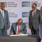 President William Ruto signs visitors book, seen by NSE Chairman Kiprono Kittony(l) Dr Chris Kipto PS Treasury and a top NSE official